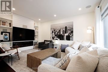 Mississauga (Mississauga Valleys) apartment for rent - A living room with a large couch and a fireplace.
