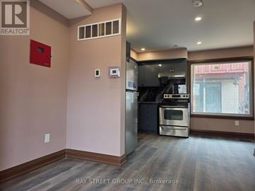 Toronto (Blake-Jones) apartment for rent - A kitchen area with a stove and a refrigerator.