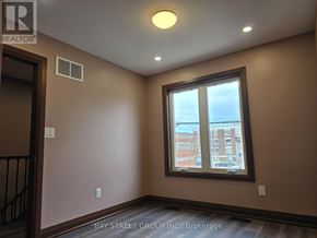 Toronto (Blake-Jones) apartment for rent - A room with a window showing a view of a building outside.