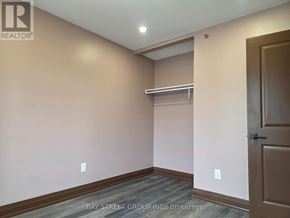 Toronto (Blake-Jones) apartment for rent - A room with a door and a shelf in it.