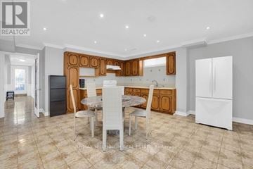 Vaughan (East Woodbridge) apartment for rent - A well-lit kitchen with a dining table and chairs in the foreground.
