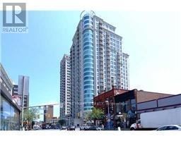 Ottawa condo for rent - A tall building with many windows is in the background.