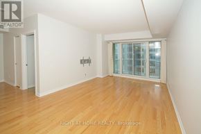 Ottawa condo for rent - A room with a wooden floor and a glass door.