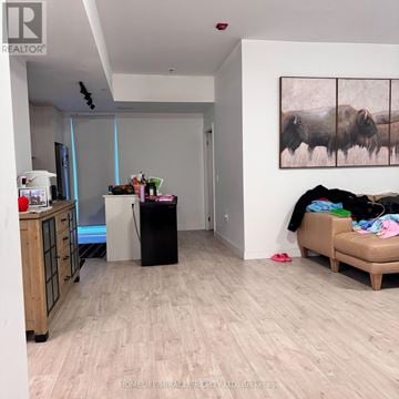 Toronto (Birchcliffe-Cliffside) townhouse for rent - A living room with a sofa, a table, and a painting on the wall.