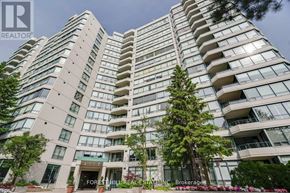 Vaughan (Brownridge) condo for rent - A tall residential building with balconies and trees in front.