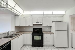 Vaughan (Brownridge) condo for rent - A kitchen with white cabinets and appliances.