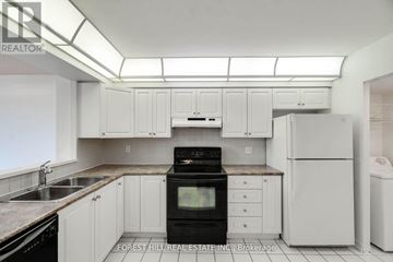 Vaughan (Brownridge) condo for rent - A kitchen with white cabinets and appliances.