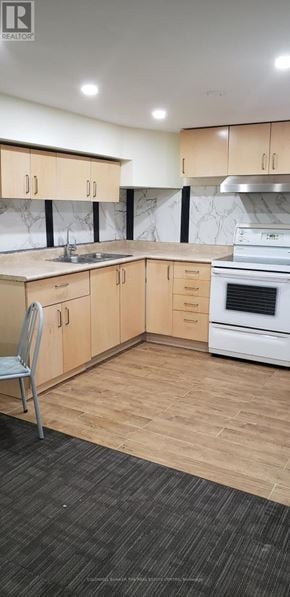 Markham (Grandview) apartment for rent - A kitchen with wooden cabinets and a white oven.