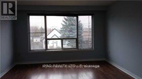 Richmond Hill (Harding) triplex for rent - A room with a window showing a view of a house and a tree outside.