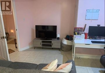 Mississauga (East Credit) apartment for rent - A living room with a television and a laptop on a desk.