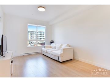 Langley apartment for rent - A living room with a white couch and a television.