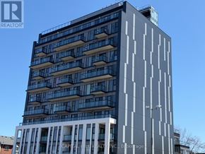 Toronto (West Hill) condo for rent - A tall building with a blue sky in the background.