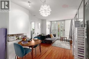Vancouver apartment for rent - A modern living room with a dining table and chairs.