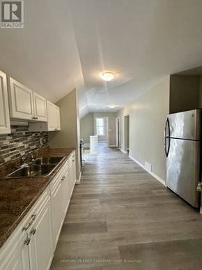 St. Thomas multi-family for rent - A kitchen with white cabinets and a marble countertop.