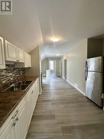 St. Thomas duplex for rent - A kitchen with white cabinets and a marble countertop.