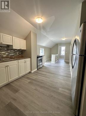 St. Thomas multi-family for rent - A kitchen with a refrigerator on the right side.