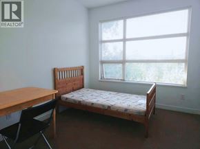 Vancouver apartment for rent - A bedroom with a bed, desk, and chair.