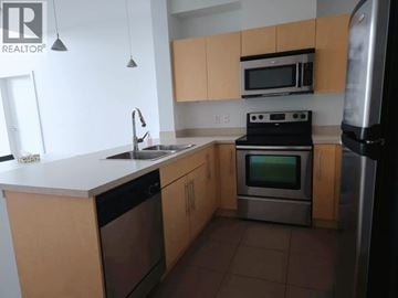 Vancouver apartment for rent - A kitchen with a stove top oven and a microwave above it.