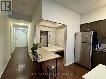 Toronto (Bay Street Corridor) condo for rent - A kitchen with a refrigerator, table and chairs.
