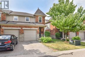 Guelph (Clairfields/Hanlon Business Park) townhouse for rent - A house with a car parked in front of it.