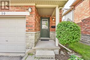 Guelph (Clairfields/Hanlon Business Park) townhouse for rent - A house numbered 10 with a green door and a white garage door.