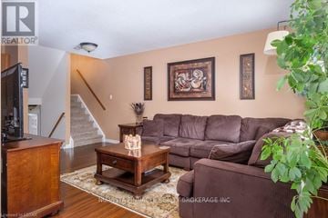 London North (North C) townhouse for rent - A living room with a brown couch and a wooden coffee table.