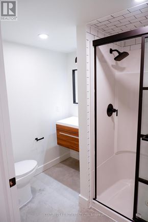 Innisfil (Lefroy) multi-family for rent - A white bathroom with a toilet and a walk in shower.