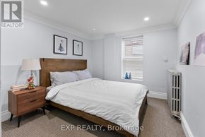 Niagara Falls (Dorchester) apartment for rent - A bedroom with a bed, nightstand, and window.