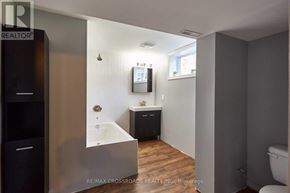 Whitby (Downtown Whitby) apartment for rent - A bathroom with a tub, sink, and toilet.