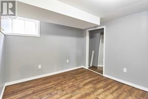 Whitby (Downtown Whitby) apartment for rent - A room with a wooden floor and a grey wall with a window.