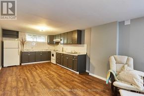 Whitby (Downtown Whitby) apartment for rent - A kitchen with wooden floors and white appliances.