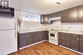 Whitby (Downtown Whitby) apartment for rent - A kitchen with a white fridge and wooden floors.