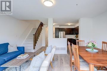 Collingwood house for rent - A living room with a blue couch and a wooden table.