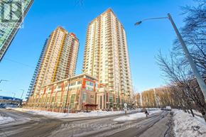 Toronto (Bendale) condo for rent - A street view of a residential area with two tall buildings and a road in front.