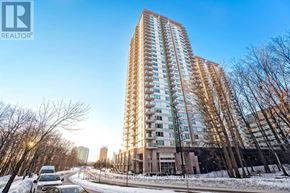 Toronto (Bendale) condo for rent - A tall residential building with a car parked in front of it.
