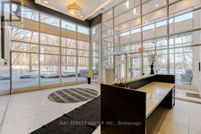 Toronto (Bendale) condo for rent - A reception area with a desk and a view of the outdoors through the windows.