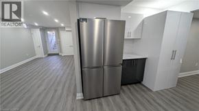 Hamilton apartment for rent - A modern kitchen with a stainless steel refrigerator and wooden flooring.