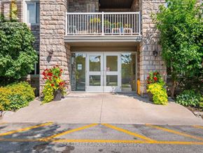 Toronto (Clairlea-Birchmount) condo for rent - The entrance to a building with a glass door and a balcony.