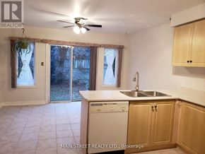 Georgina (Keswick South) apartment for rent - A kitchen with a washer and dryer built in.