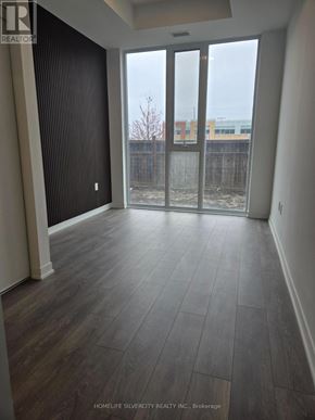 Burlington (Alton) condo for rent - A room with a sliding glass door leading to a backyard.