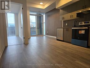 Burlington (Alton) condo for rent - A spacious kitchen and living room with wooden floors and modern appliances.