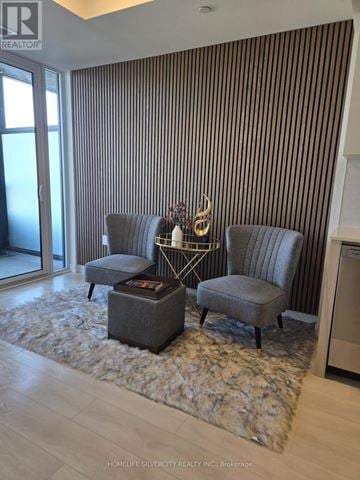Burlington (Alton) condo for rent - A living room with a grey sofa and a coffee table.