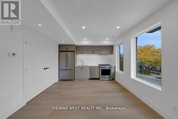 Toronto (Oakwood Village) apartment for rent - A spacious kitchen with white cabinets and a large window.