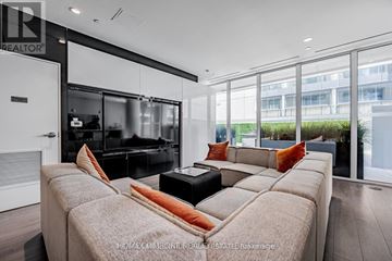 Toronto (Church-Yonge Corridor) condo for rent - A modern living room with a large couch and a television.