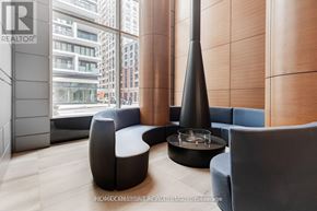 Toronto (Church-Yonge Corridor) condo for rent - A modern living room with a large window and a fireplace.