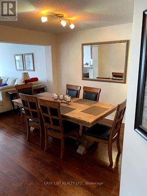 Ottawa townhouse for rent - A dining room with a wooden table and chairs.