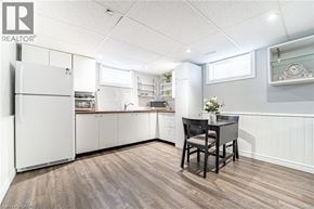 Hamilton apartment for rent - A kitchen with white appliances and a wooden floor.