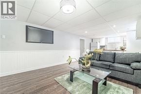 Hamilton apartment for rent - A living room with a grey couch and a glass coffee table.