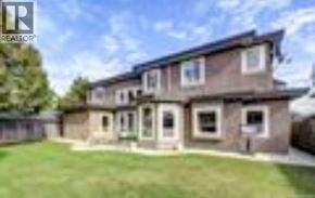 Richmond apartment for rent - A brown house with a green lawn in front.
