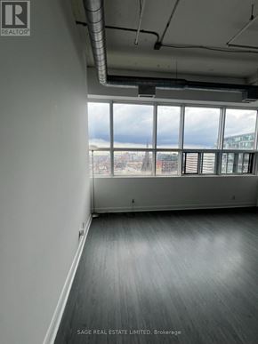 Toronto (Niagara) condo for rent - A room with a view of the city through large windows.